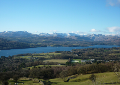 Distance shot of Lake Windemere showing snow capped mountains